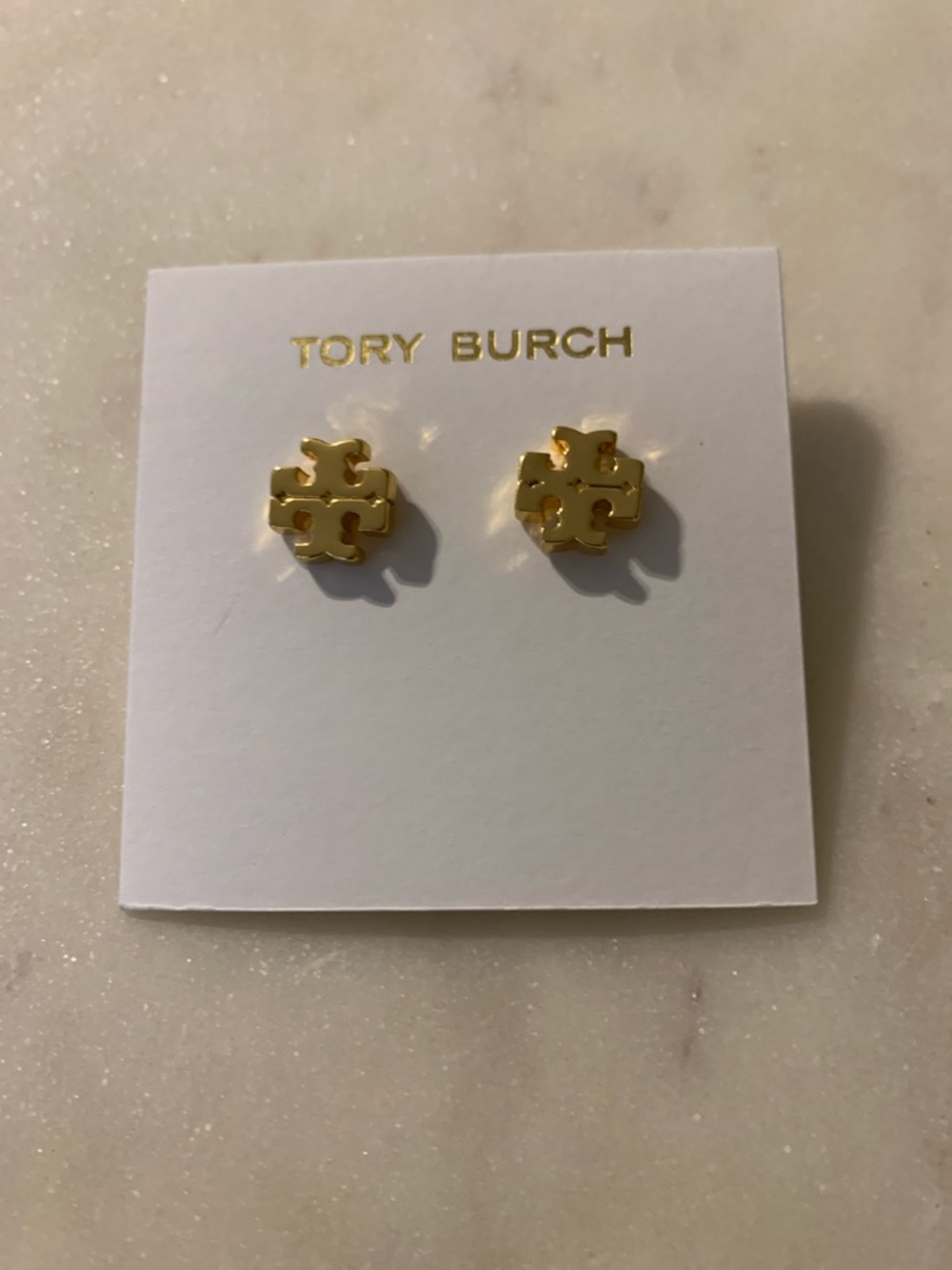 Tory Burch Gold Logo Stud Earrings on Card